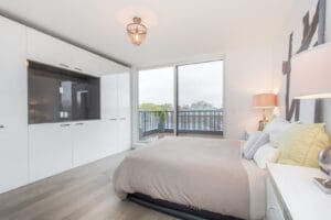 Bright modern bedroom with large windows and minimalistic design.