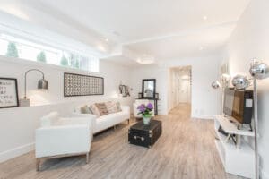 Bright living room with white sofa and wooden floor.