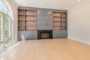 Modern built-in shelving with a fireplace in a minimalist room.