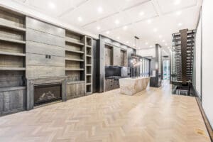 Modern living room with sleek fireplace and marble island.