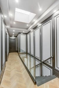 Elegant hallway with paneled walls and recessed ceiling lights.