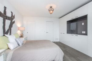 Minimalist bedroom with neutral tones and modern decor.