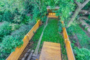 A serene backyard garden with wooden fences and lush greenery.