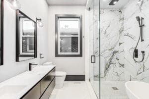 Modern bathroom with glass shower and marble accents.