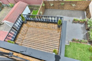 View of a wooden deck and garden area from above.