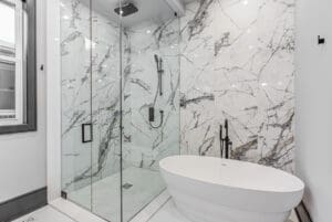 Modern bathroom with glass shower and freestanding tub.