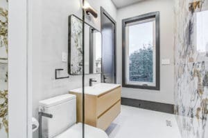 Modern bathroom with a floating vanity and large window.