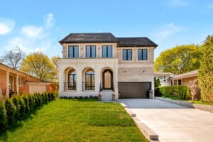 Modern two-story house with brick exterior and arched windows.
