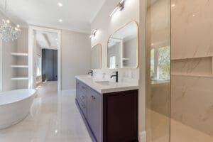 Modern bathroom with double sinks and large mirrors.