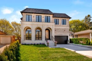 A modern two-story house with arched windows and a front lawn.