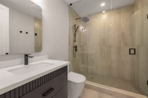 Modern bathroom with glass shower and sleek vanity.