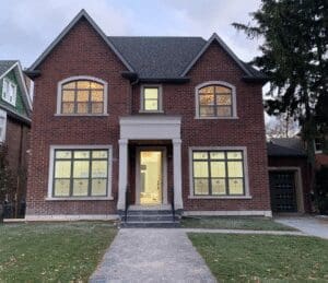 A large two-story brick house with multiple windows and a central entrance.