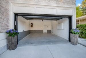 Empty garage with tiled walls and concrete floor.
