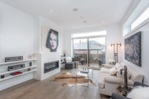 Bright modern living room with white furniture and large windows.
