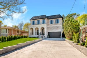 Modern two-story house with large driveway and garage.