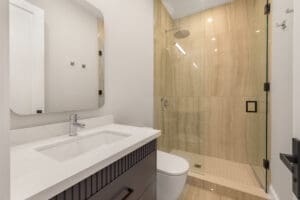 Modern bathroom with a glass shower enclosure and sleek vanity.